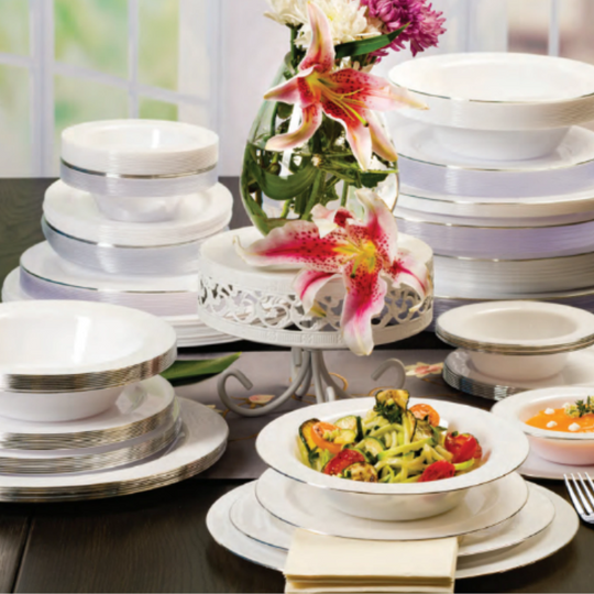 Set of white dinnerware with colorful flowers on a table