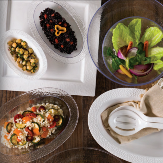 Assorted salads and dishes on a wooden table