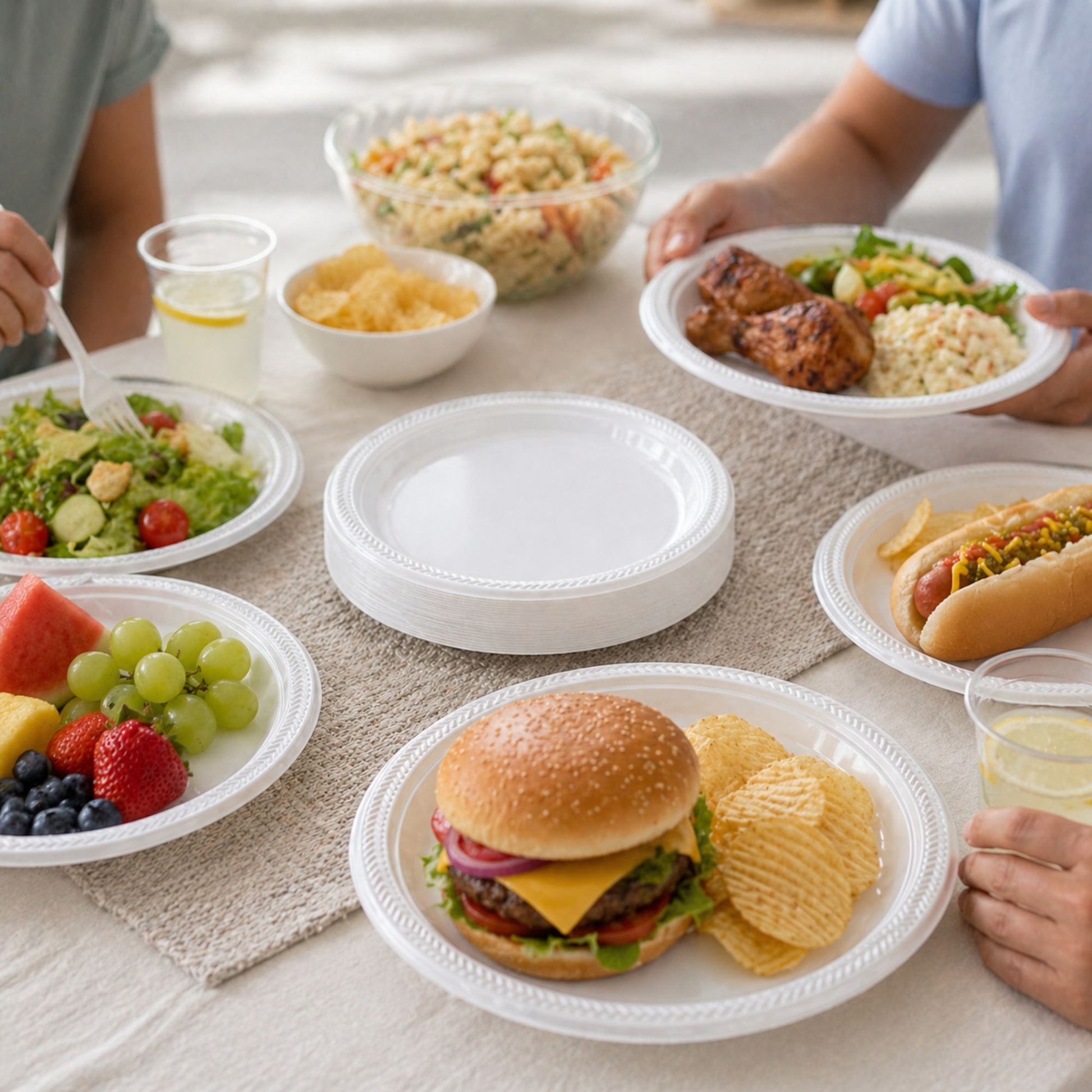 People enjoying a meal with various food items on a table.