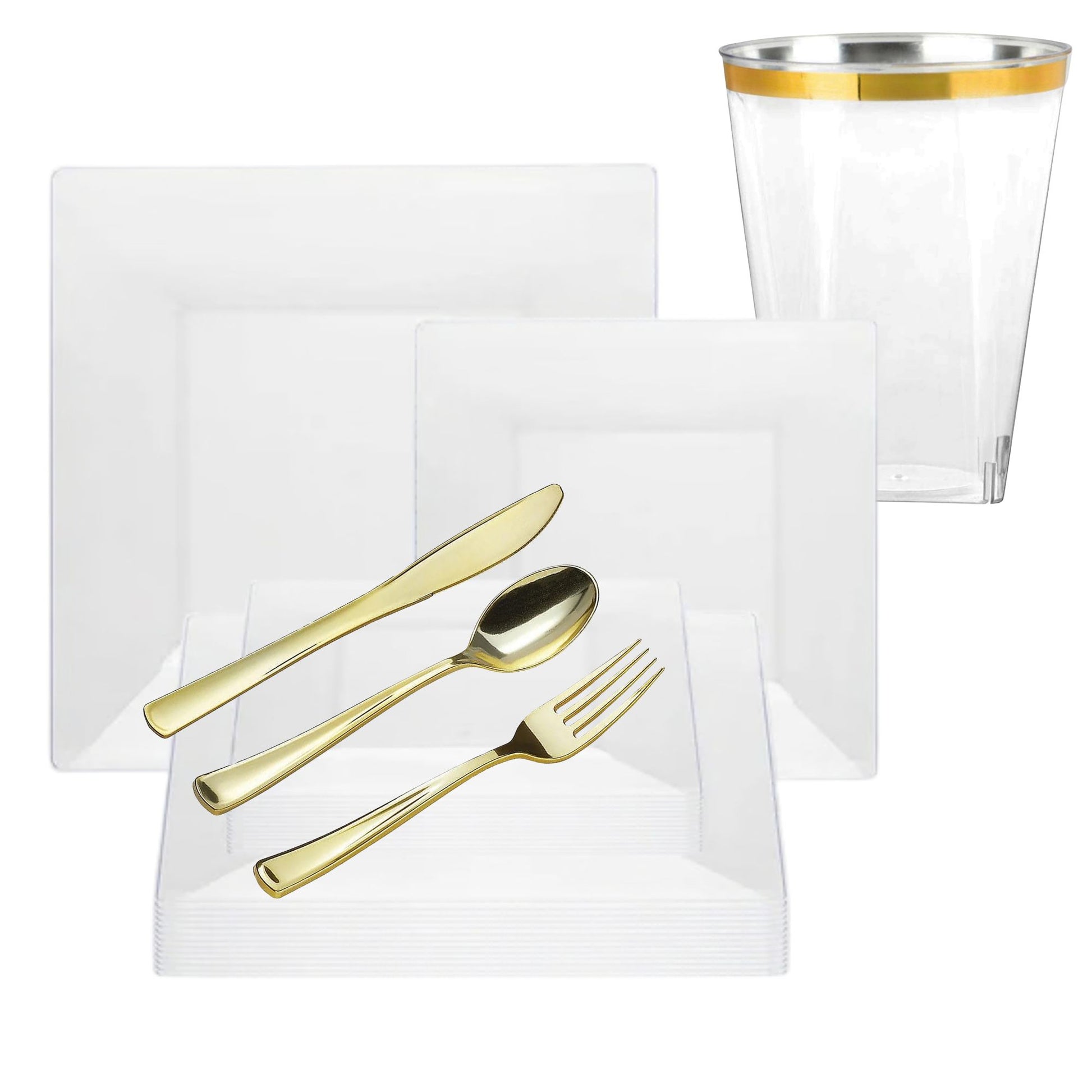 Gold cutlery set on a white napkin with a clear glass featuring a gold rim.