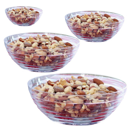 Four clear glass bowls filled with a mix of nuts on a white background